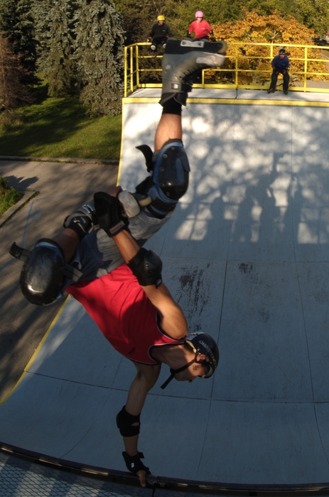 In-Line Skater Rollerblading a Half-Pipe Handstand