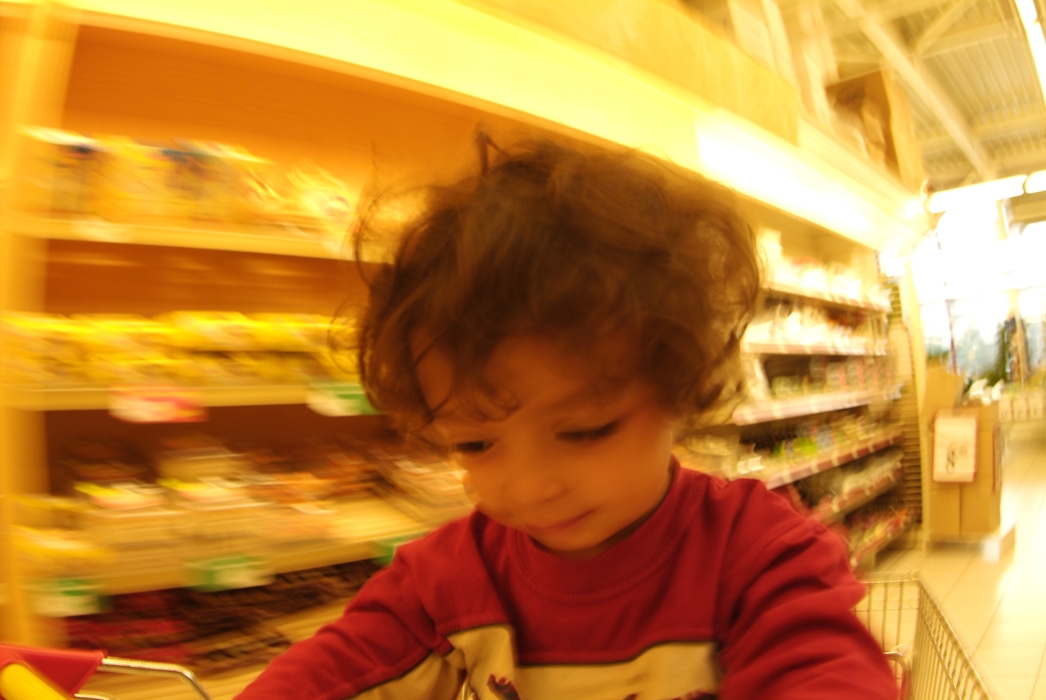 Child Pushing Grocery Cart at Supermarket