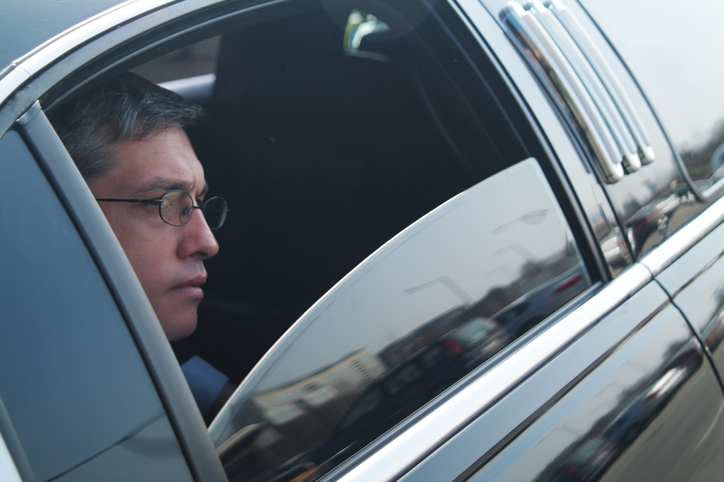 Businessman Traveling in a Limousine