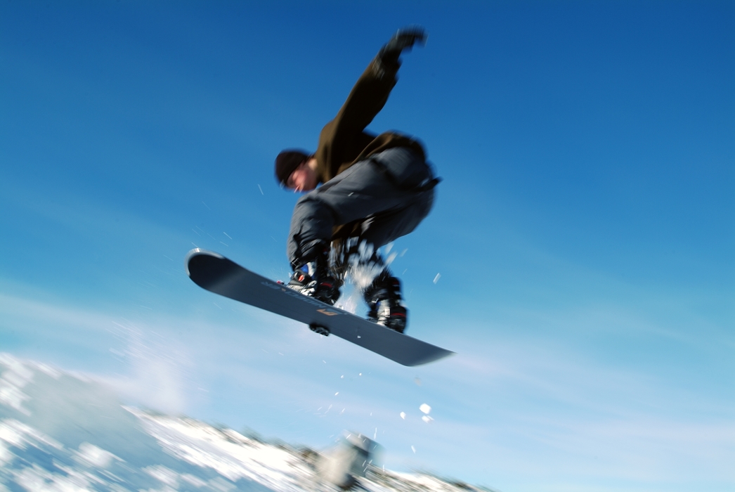 Snowboarder Jumping and Getting Some Air