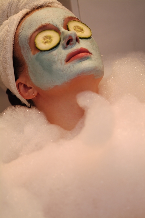 Woman Soaking in The Bath with a Mud Mask
