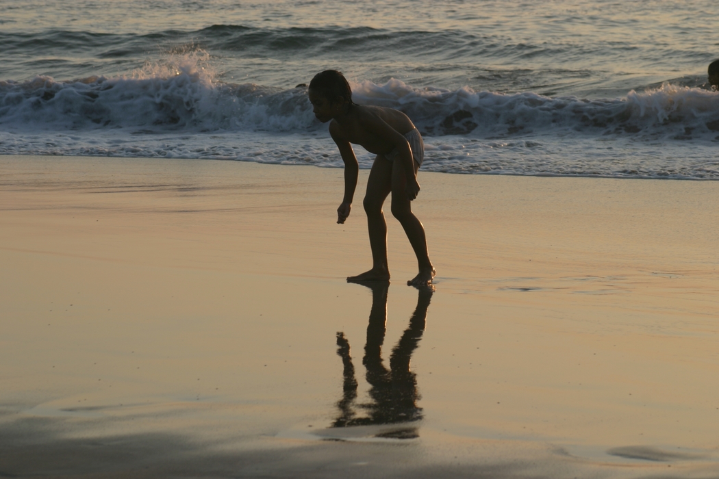 Boy Playing At The Beach