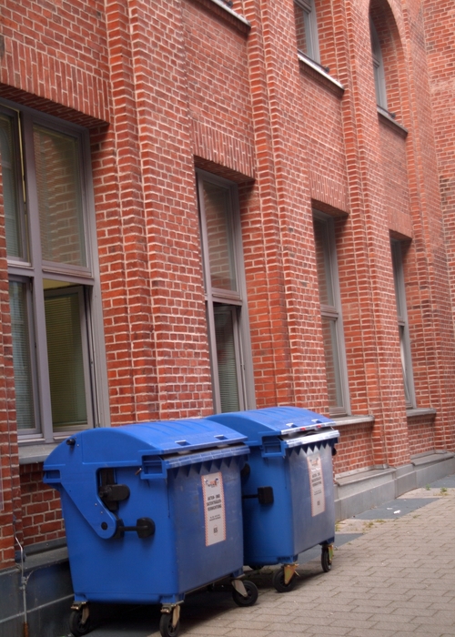 Waste Containers Beside Brick Office Building
