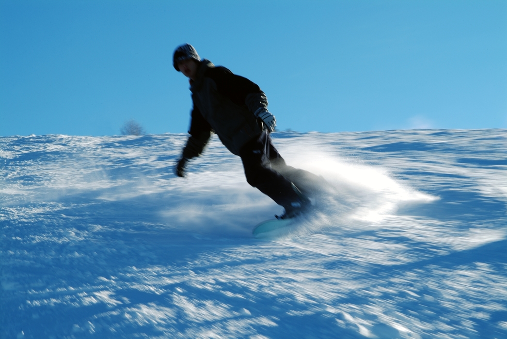 Snowboarder Carves His Way Down a Hill