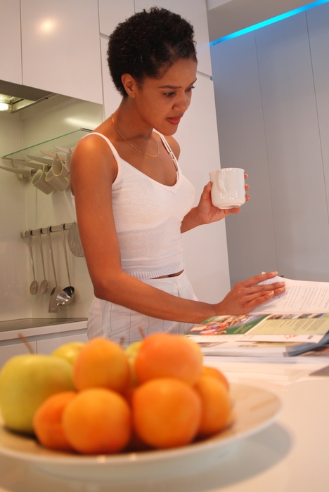 Woman Having Coffee in Kitchen