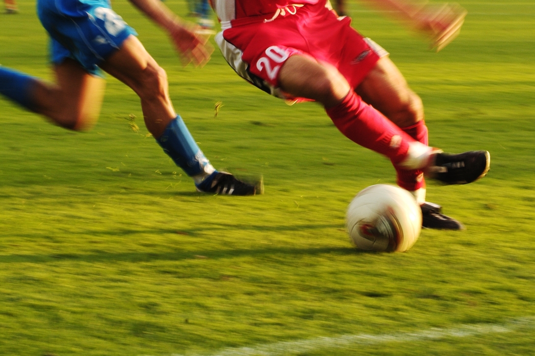 European Football: Soccer Player Advances the Ball