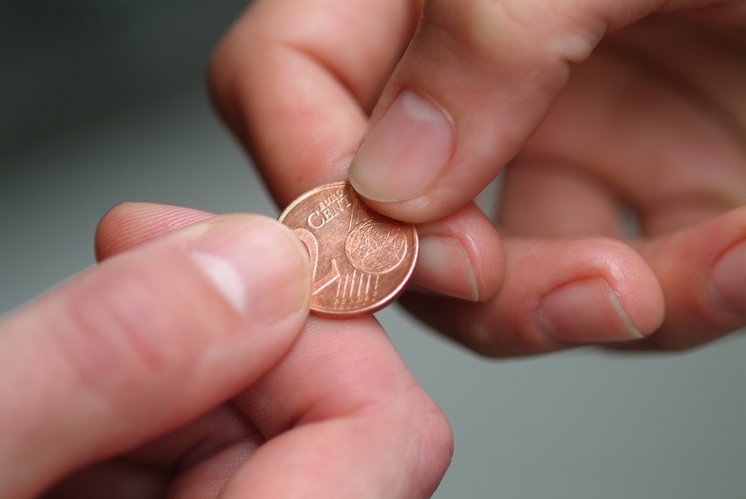 Hands Holding Euro Coin