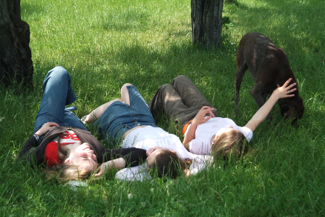 Girls Playing in the Park with Their Dog