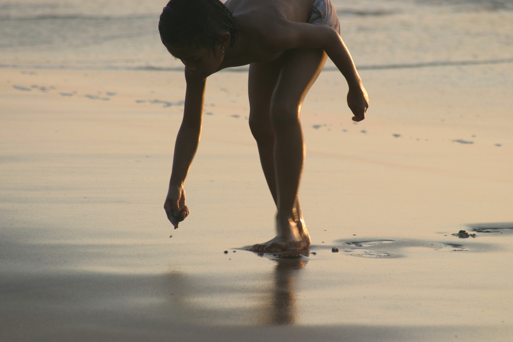 Boy Playing At The Beach