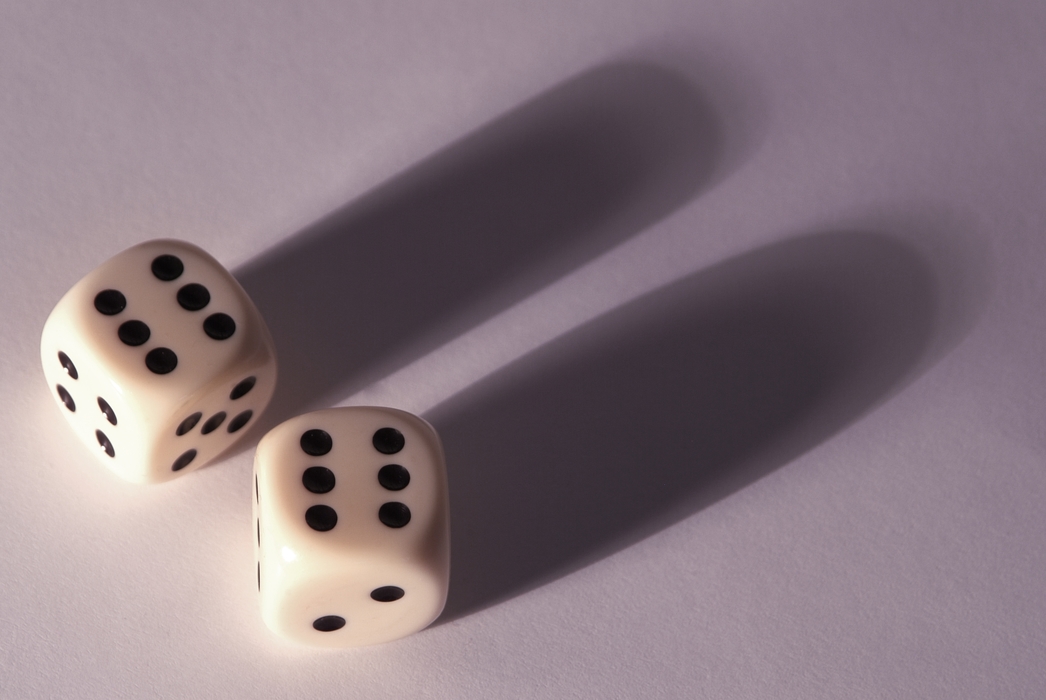 Dice Rolls Double Sixes with Dramatic Shadow