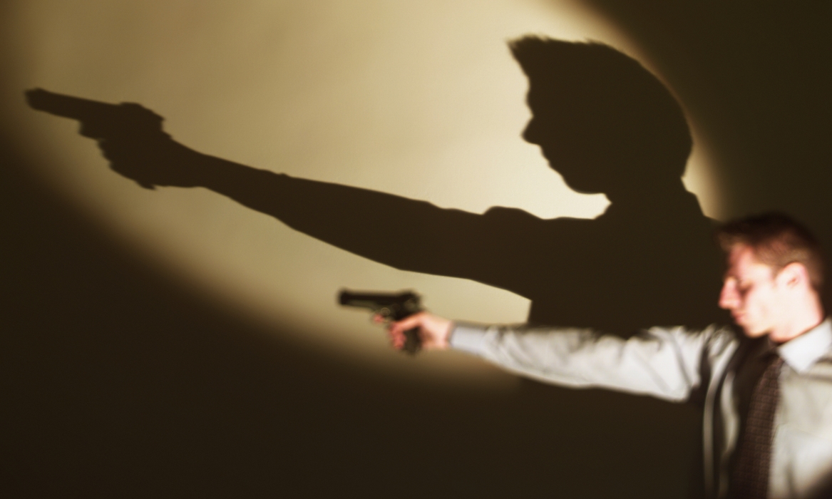 Businessman Pointing Gun with Shadow