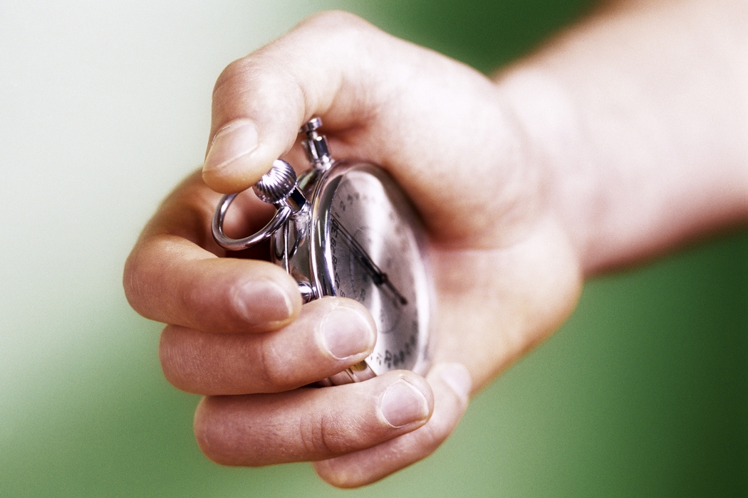 Hand Holding a Stopwatch