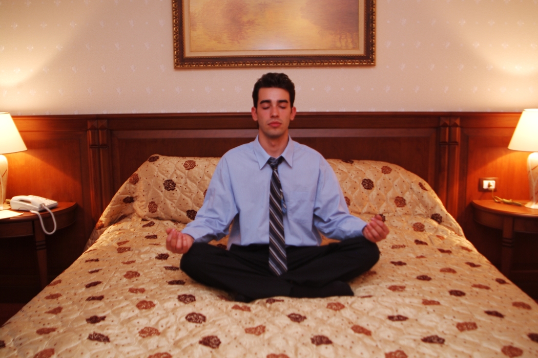 Businessman Meditating in Bed
