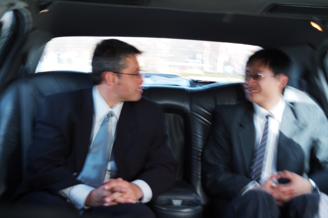 Businessmen Traveling in a Limousine