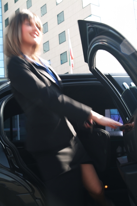 Businesswoman Getting Out of a Limousine