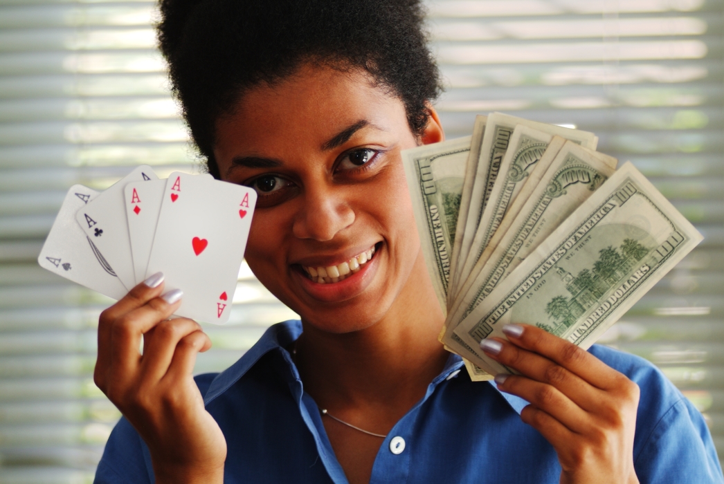 Woman Holding Poker Hand & Cash
