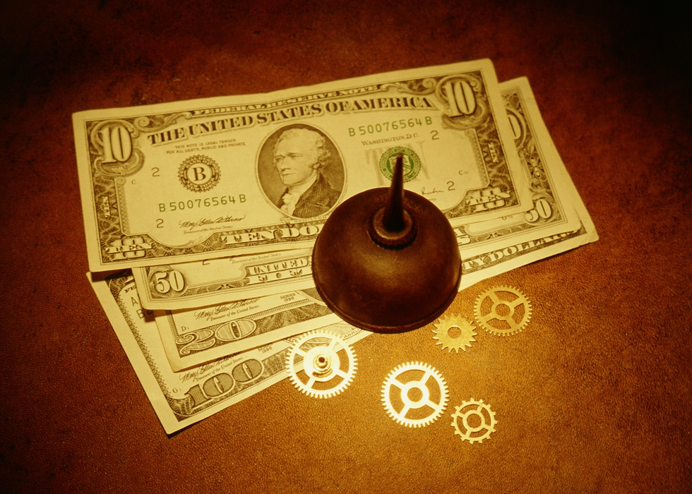 Oil Can and Gears on Top of $ Bills