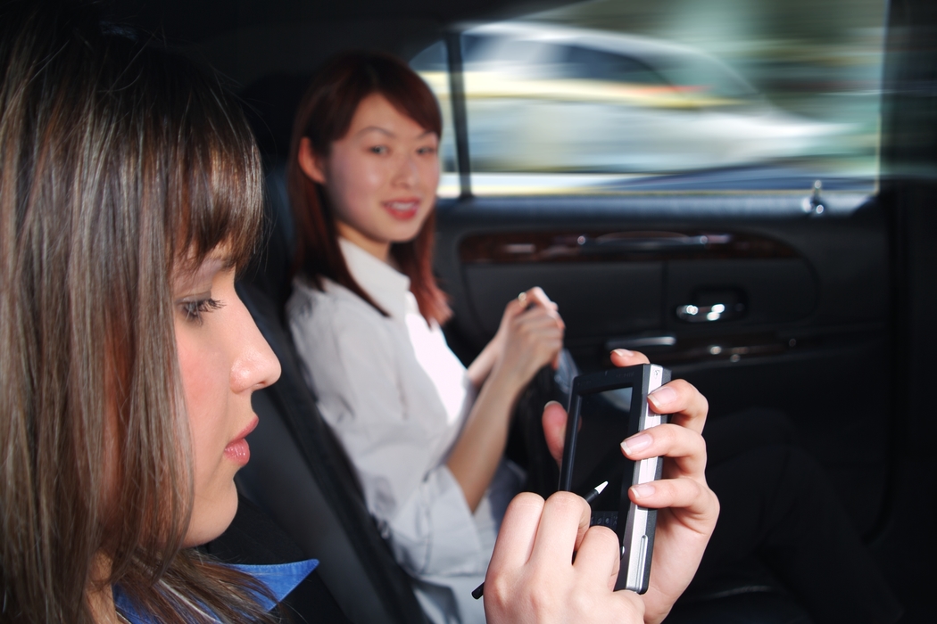 Businesswomen Working in a Limousine