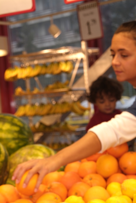 Selecting Oranges at Supermarket