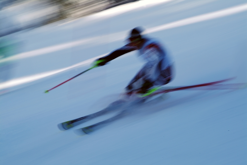 Downhill Skier Races Through the Shadows During Race