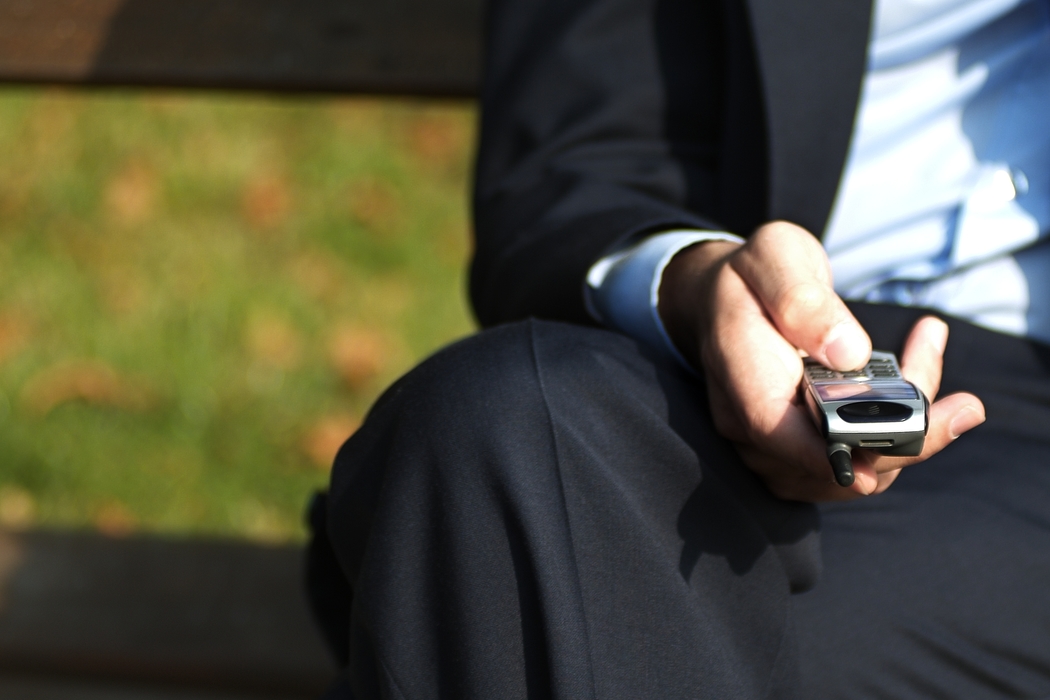 Businessman Dialing Cell Phone