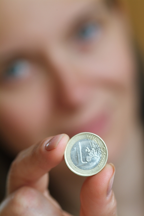 Woman Holding a 1 Euro Coin