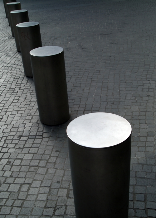 Traffic Barriers on Cobblestone Street