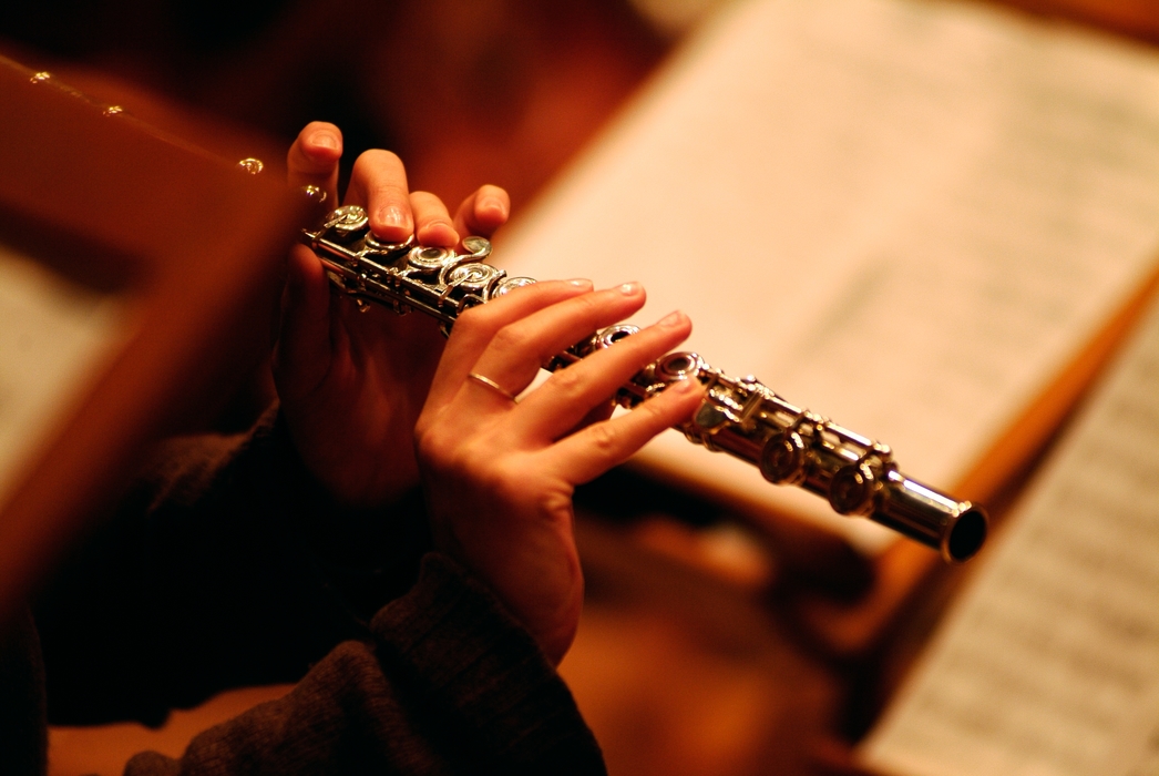 Symphony Orchestra Flutist Two Hands on Keys