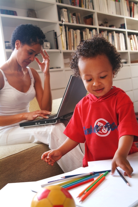 Boy Playing While Mother Works