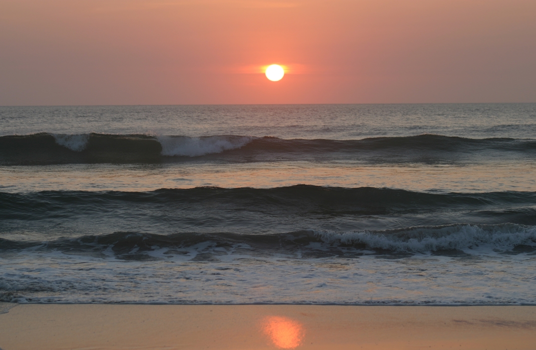 Sun Setting with Waves Breaking