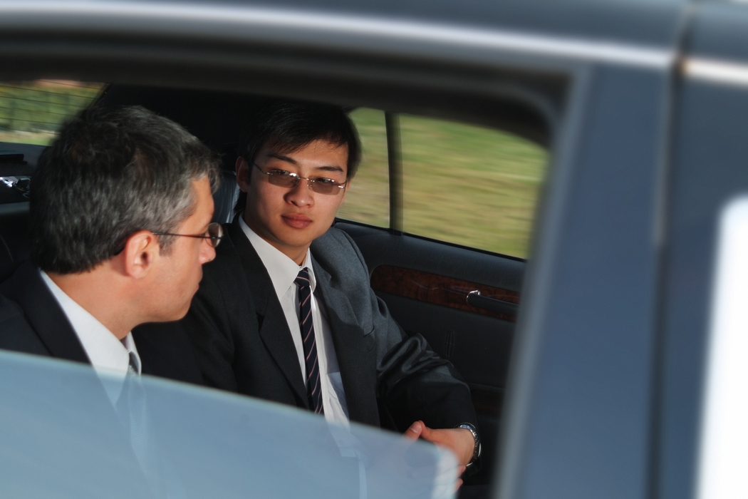 Businessmen Traveling in a Limousine