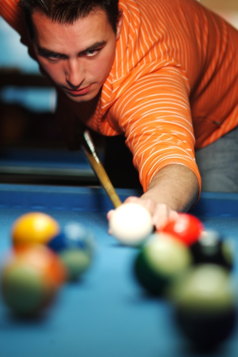 Pool Player Lining Up a Shot