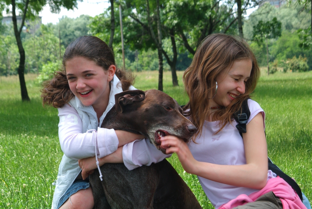 Girls Playing with Their Dog