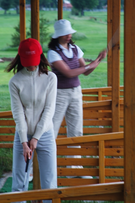 Female Golfers At The Driving Range