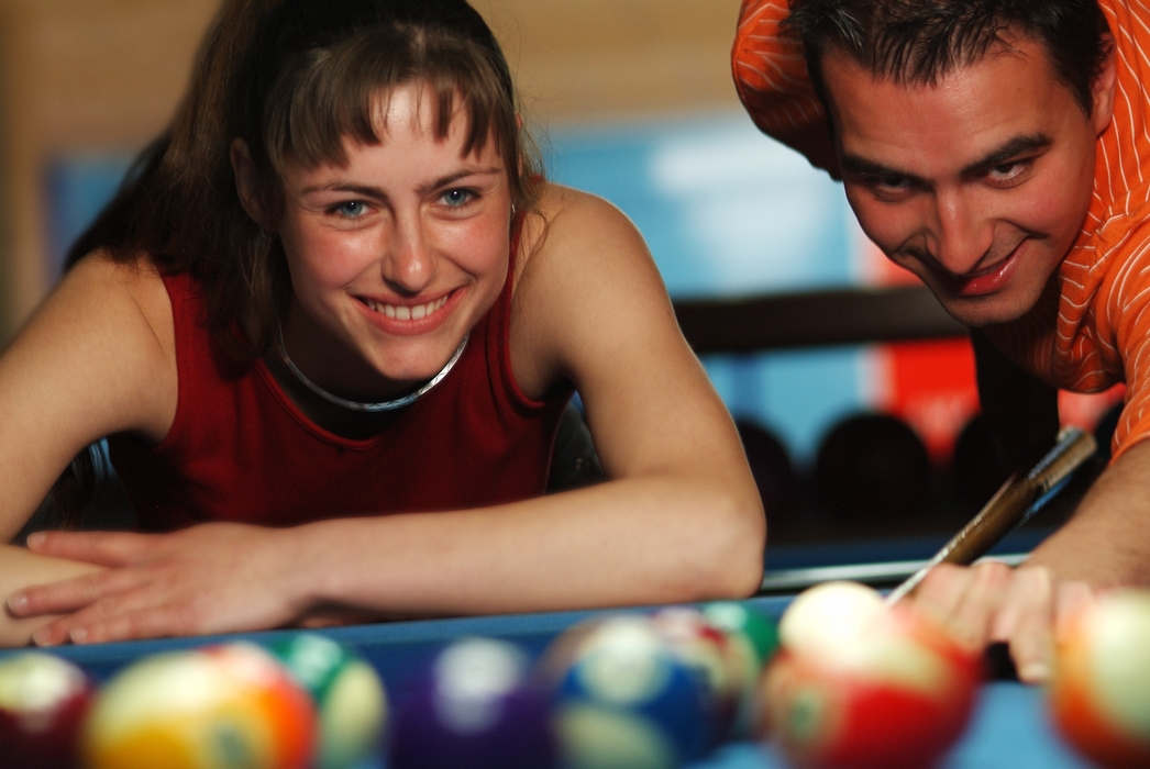 Male and Female Playing Pool