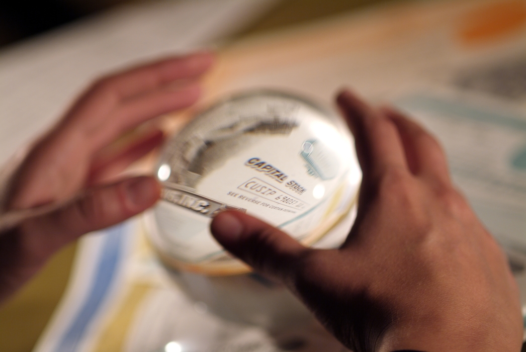 Hands and Crystal Ball with Stock Certificate Inside
