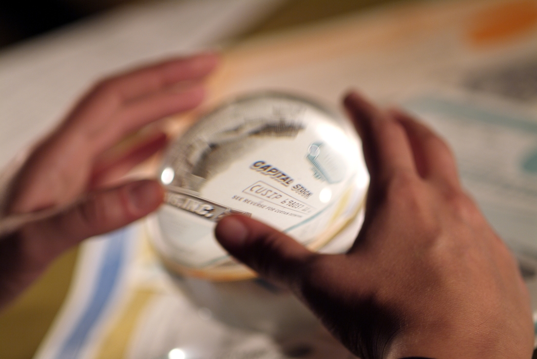 Hands and Crystal Ball with Stock Certificate Inside