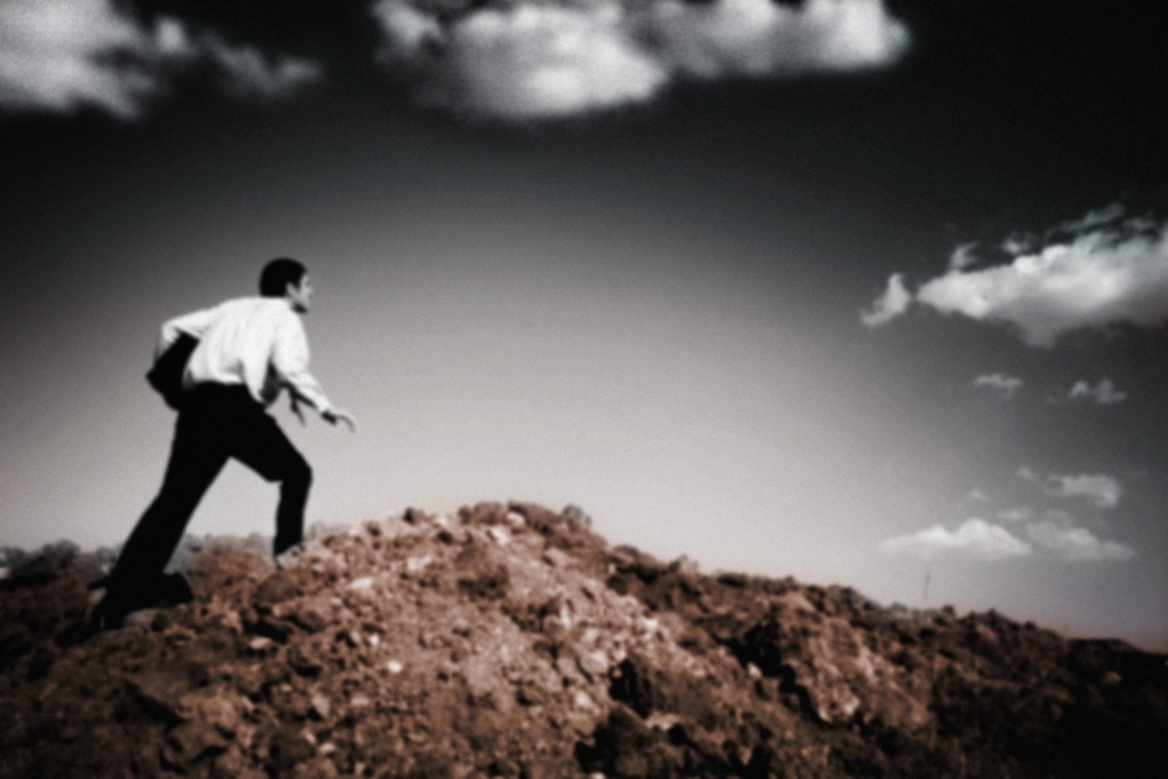 Man Reaching Top of Hill (Sample Image)