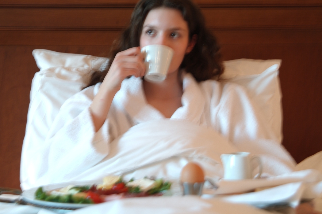 Woman Having Breakfast in Room