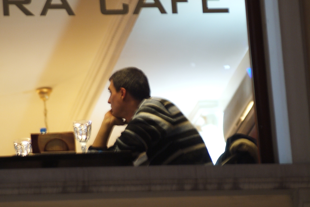 Man Having Dinner in Café