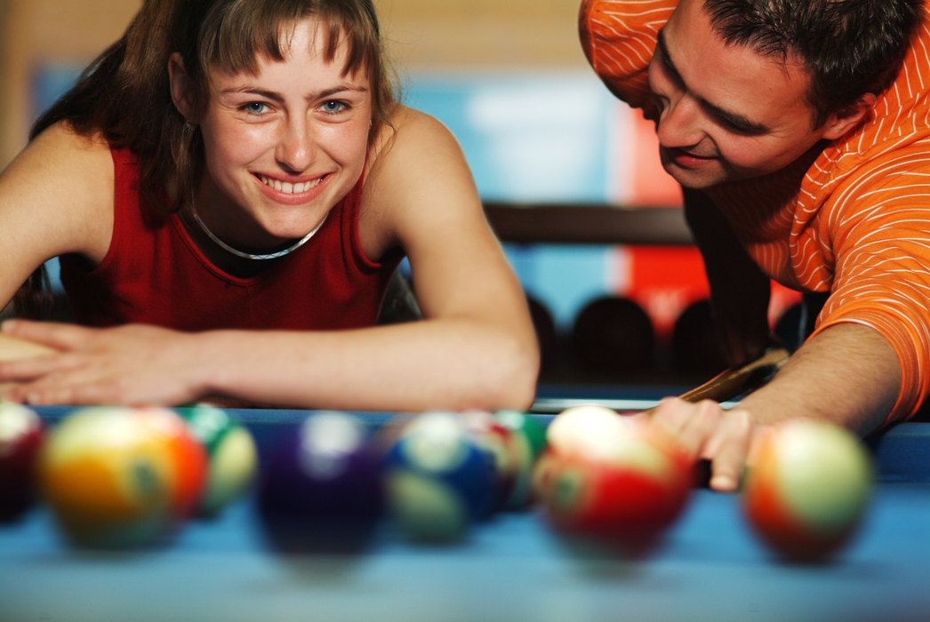 Male and Female Playing Pool