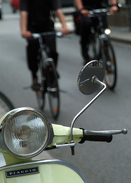 Motor Scooter with Cyclists on Street