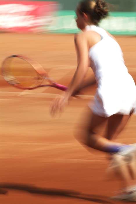 Tennis Player Reaching for Shot