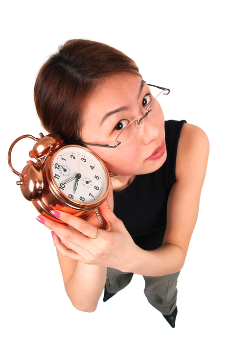 Businesswoman Listening to Alarm Clock