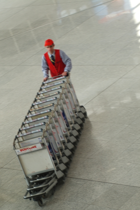 Luggage Handler Returning Luggage Carts