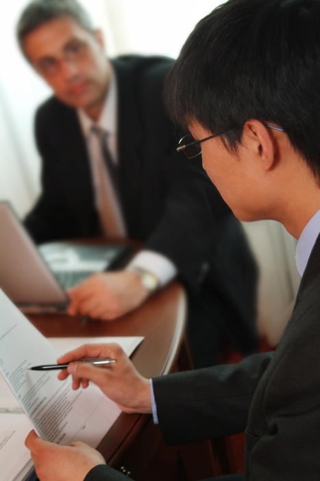 Businessmen Reviewing Documents