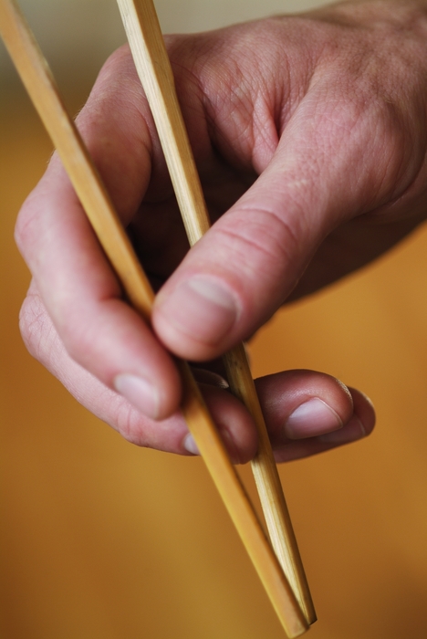 Hand Holding Chopsticks