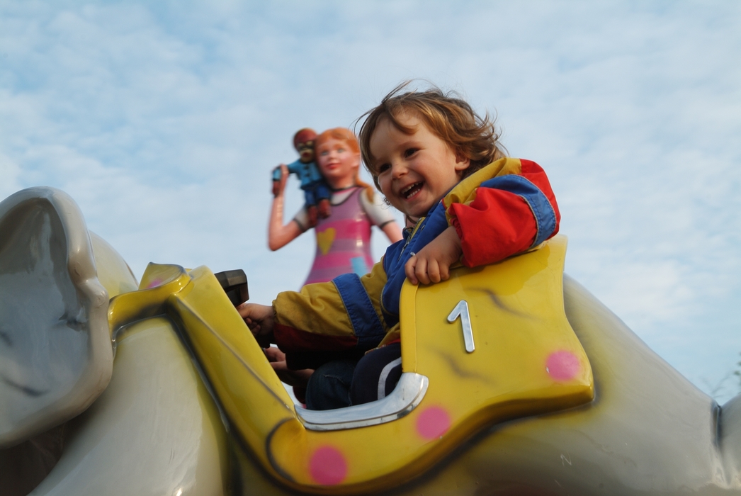 Children on a Ride At The Amusement Park