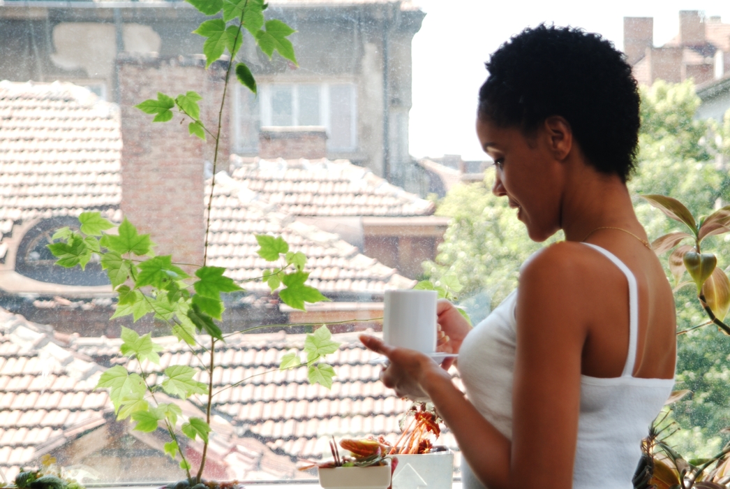 Woman Having Coffee on Her Balcony