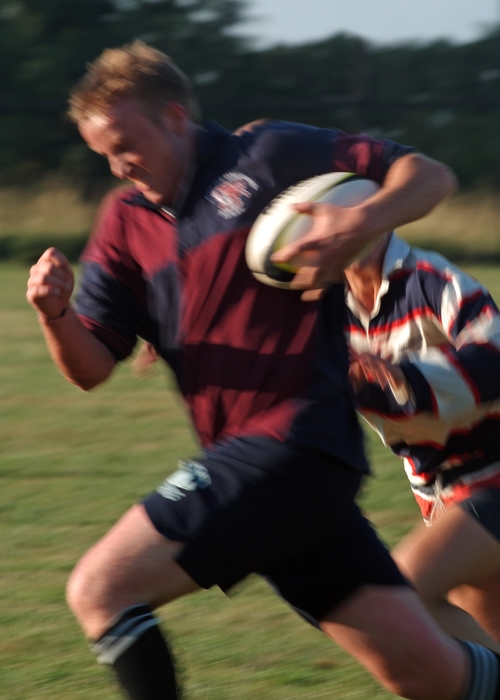 Rugby Player Runs Hard with the Ball